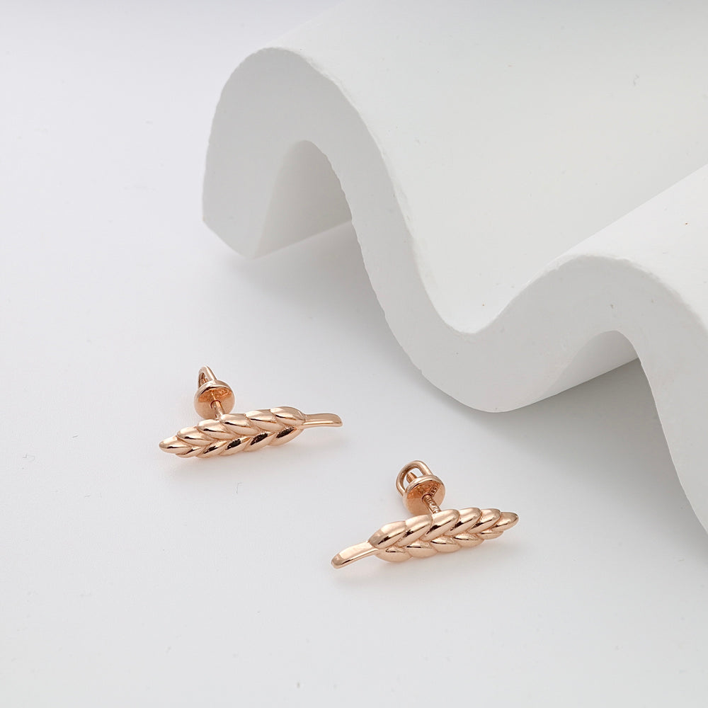 Pair of gold wheat-shaped stud earrings displayed on a white background.