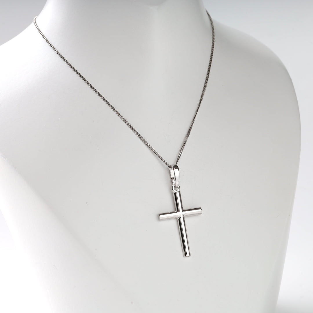 Sterling silver cross pendant necklace displayed on a mannequin.