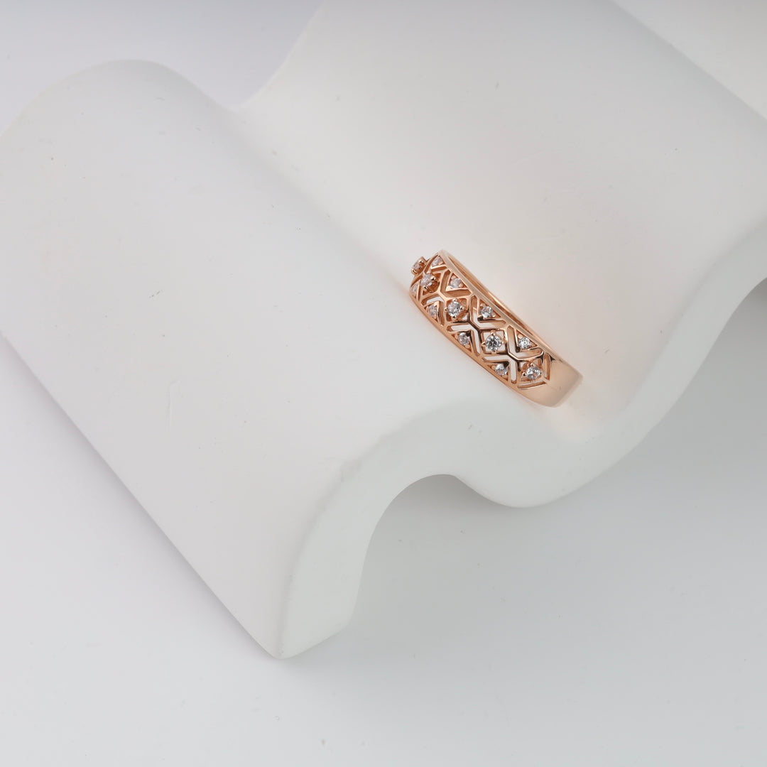 Rose gold band with diamond accents displayed on a white stand.