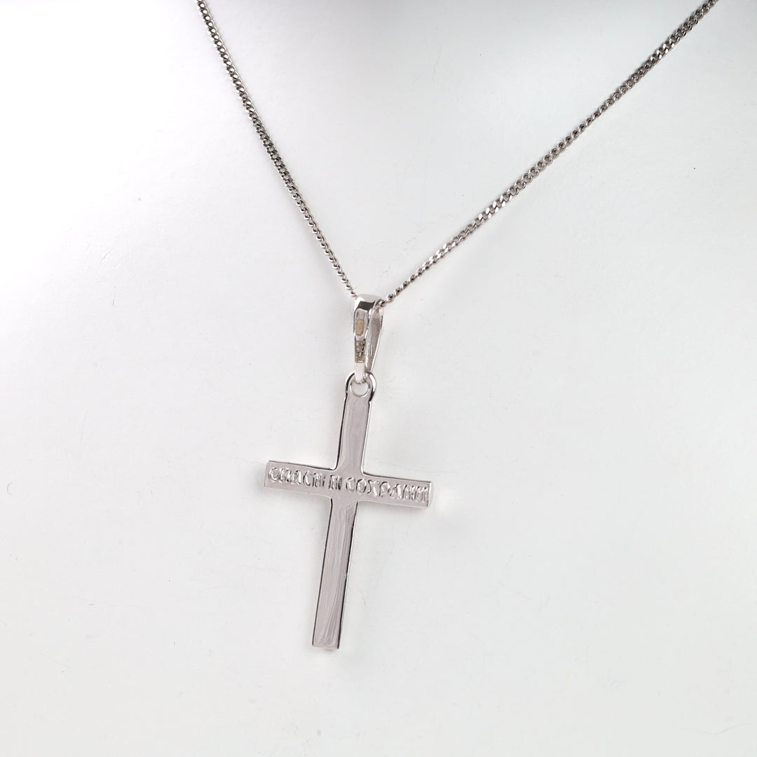 Silver cross pendant necklace with text detail on a fine chain.