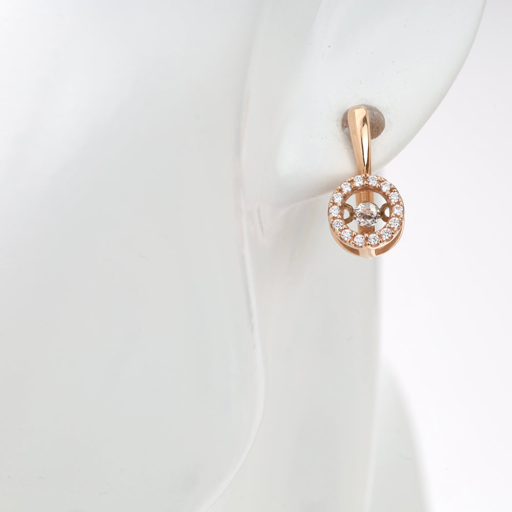 Rose gold and diamond circle stud earring on ear.