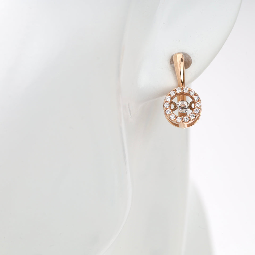 Rose gold and diamond circle stud earring on ear.