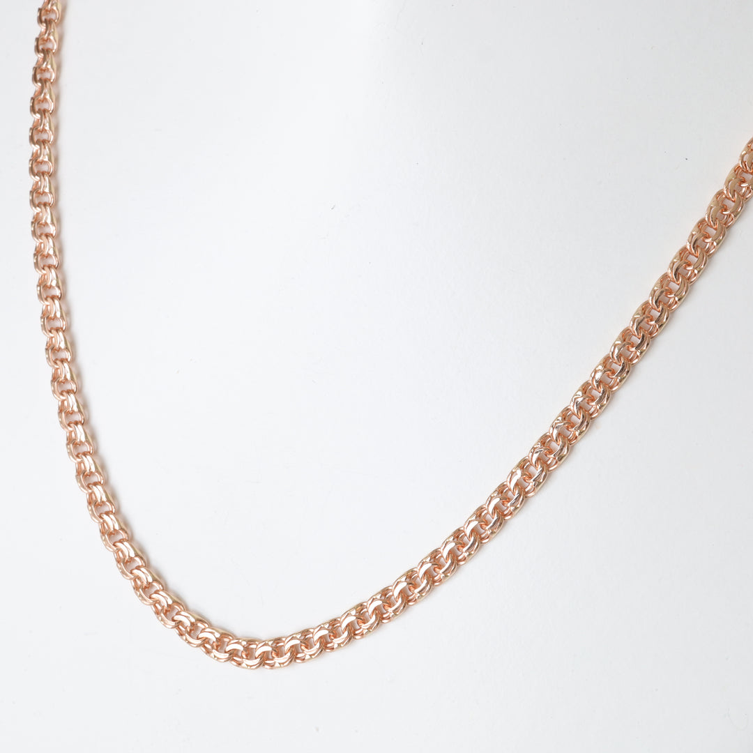 Rose gold chain necklace with round interlocking links displayed on a white background, chain jewelry, minimalist necklace.