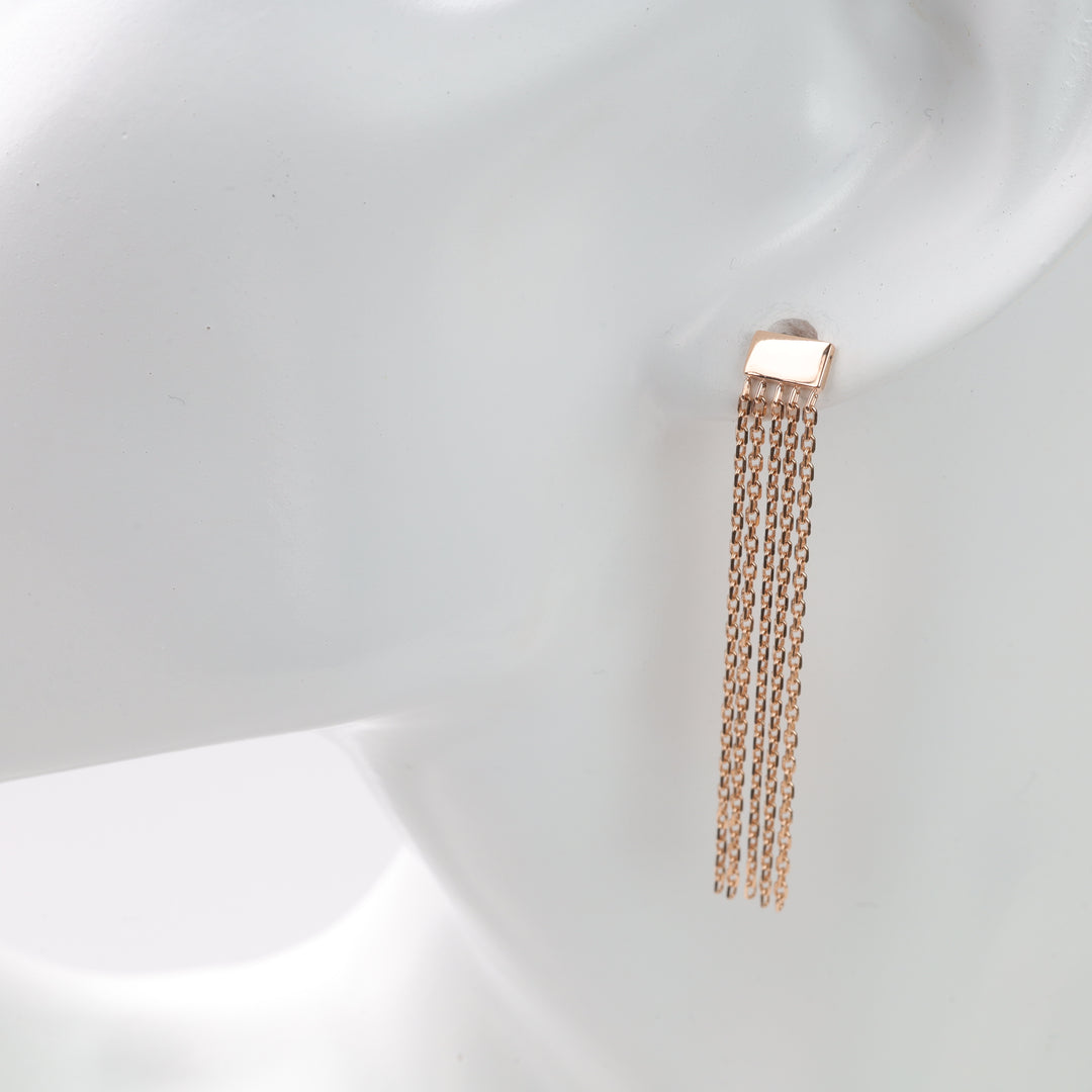 Rose gold rectangular stud with five hanging chain tassels on white ear display, rose gold tassel earrings, chain dangle earrings.