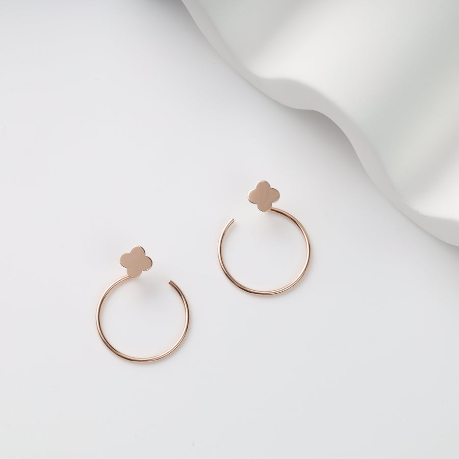 Rose gold open hoop pair with clover stud tops on white background, rose gold hoop earrings, clover stud hoops.