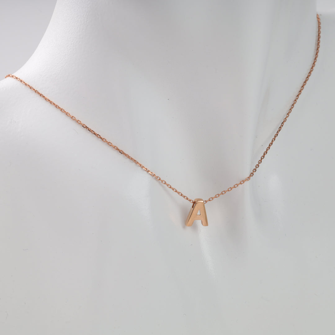 Letter A gold initial pendant necklace on a mannequin bust.