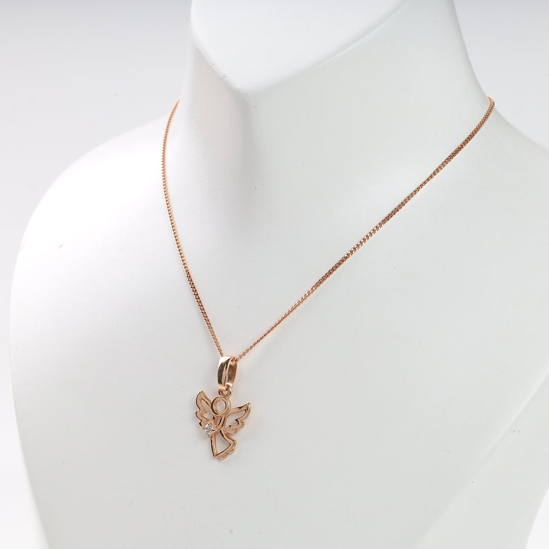 Rose gold chain necklace with an openwork angel pendant shown on a white display bust.