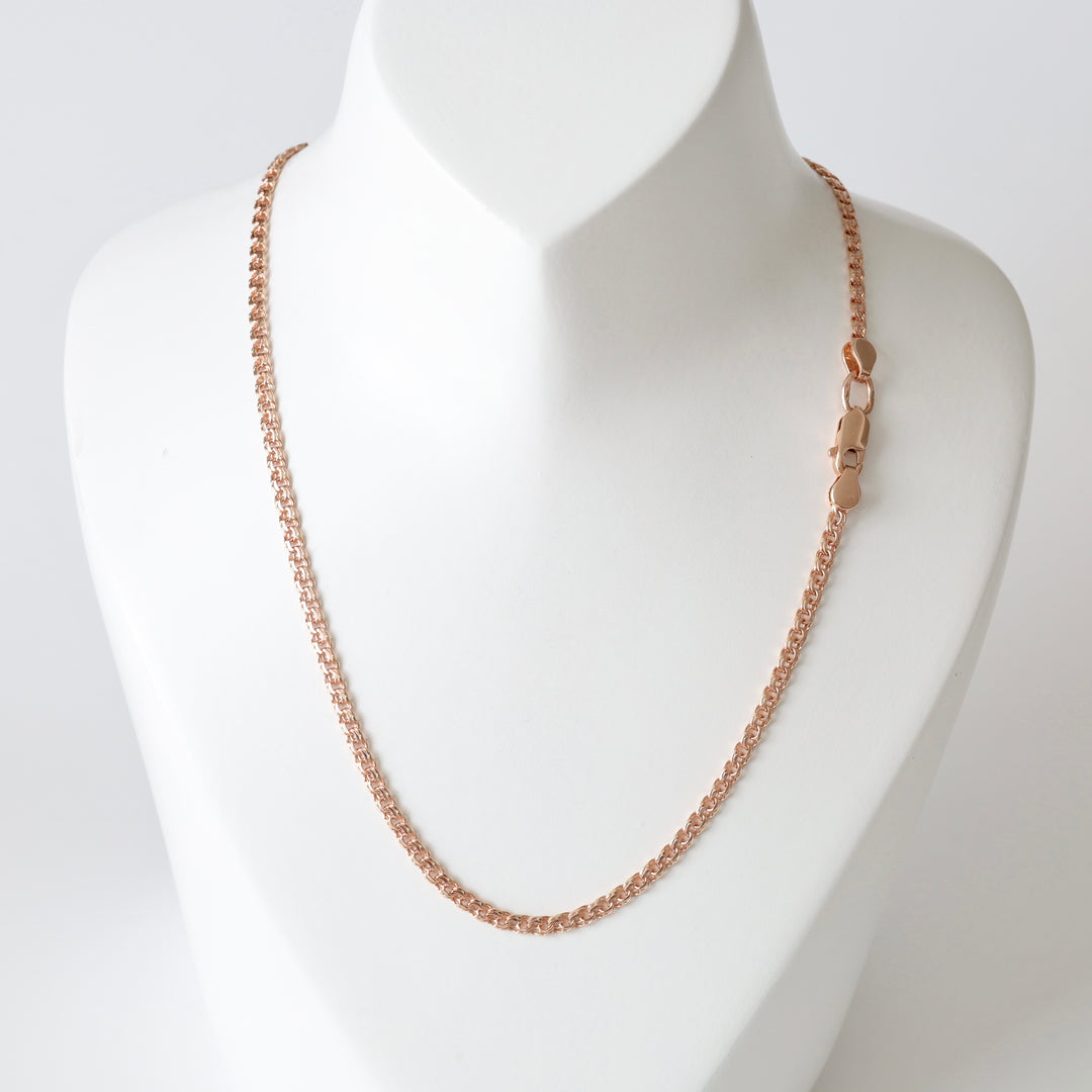 Rose gold chain necklace with a lobster clasp displayed on a white jewelry bust.