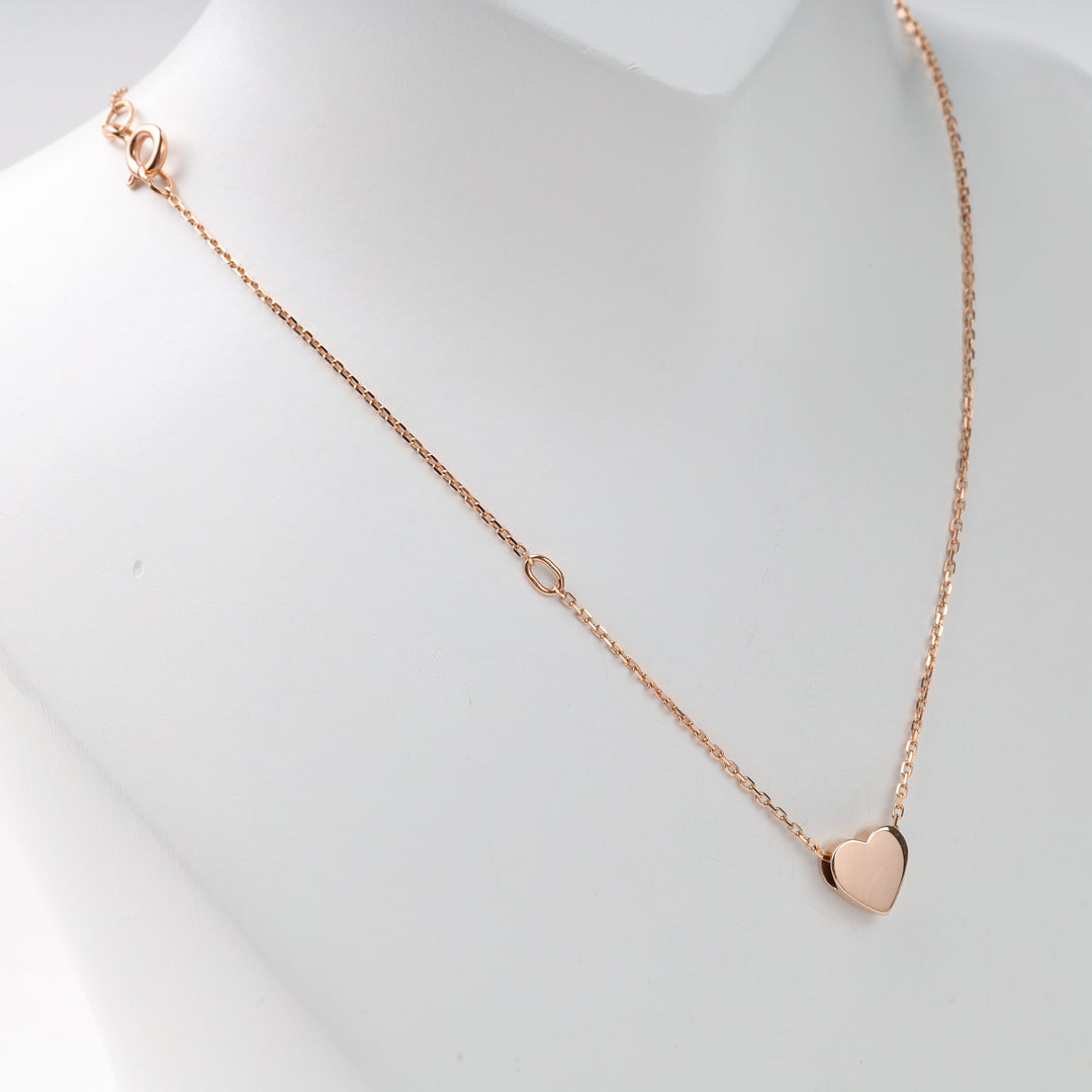 Rose gold heart pendant necklace on a white display bust with delicate chain and lobster clasp, rose gold heart necklace, delicate chain necklace.