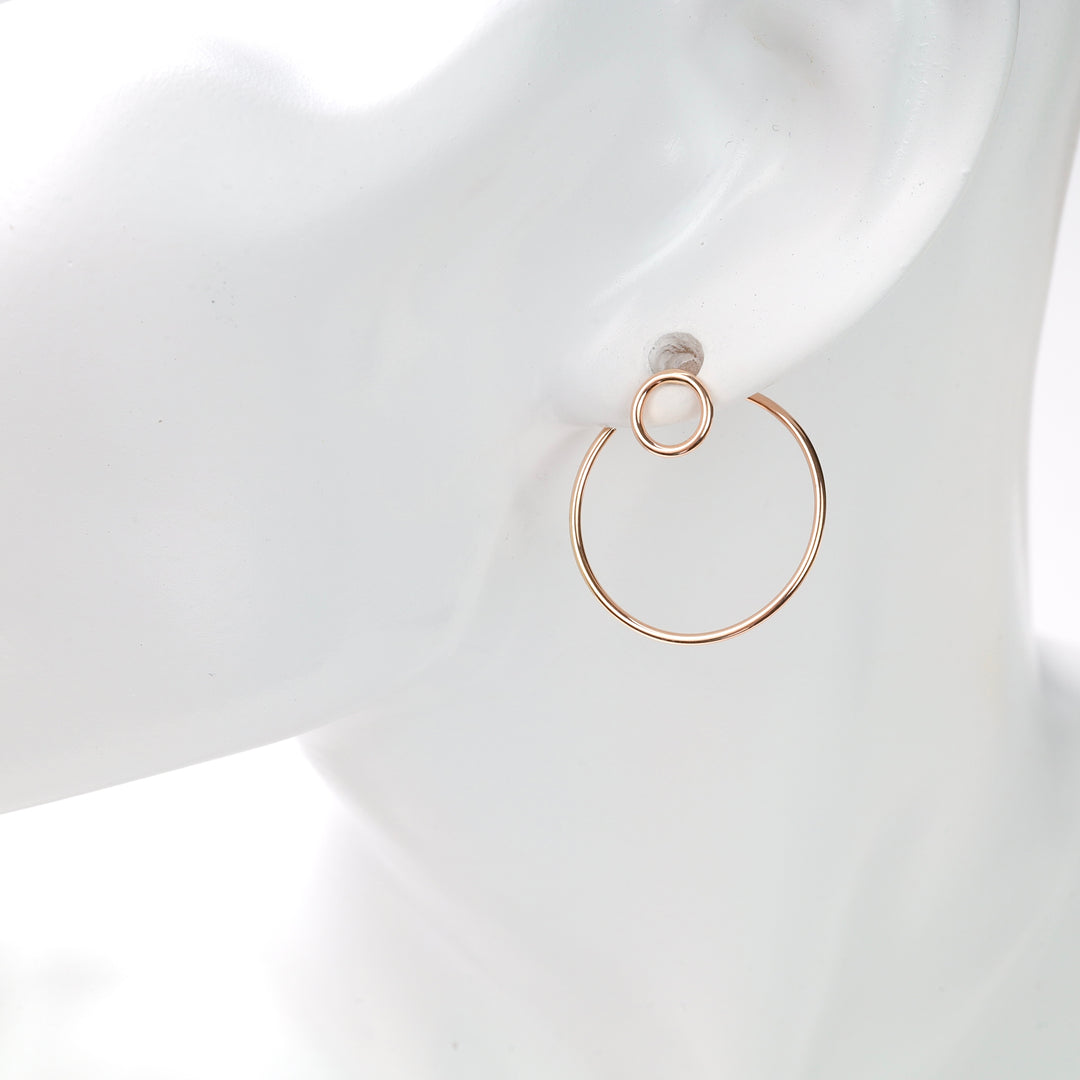 Rose gold double-circle hoop earring on a white mannequin ear, minimalist rose gold hoop earring.