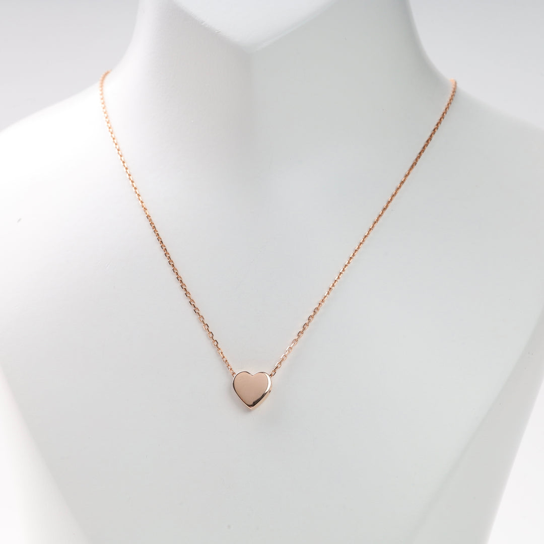 Single rose gold heart pendant necklace on white display bust with thin chain, rose gold heart necklace, heart pendant necklace.