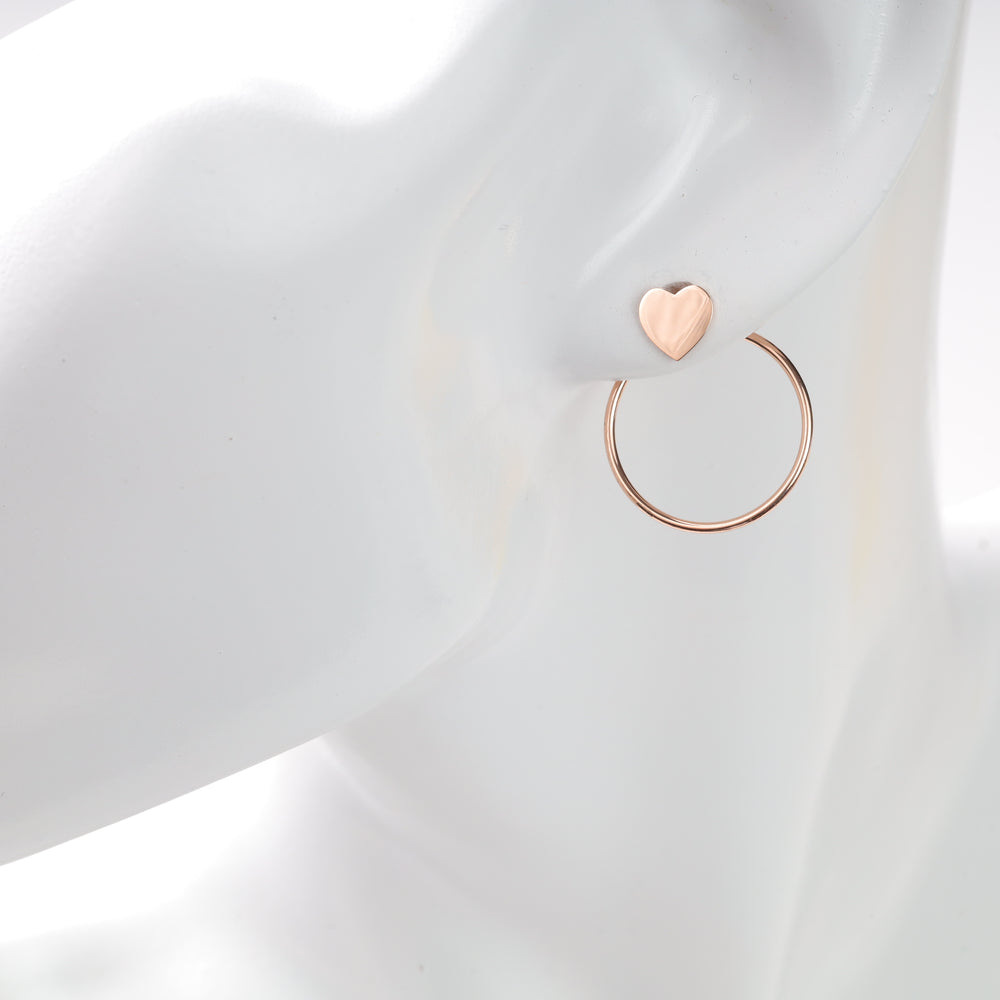 Rose gold heart stud with thin rose gold hoop earring displayed on a white mannequin ear.