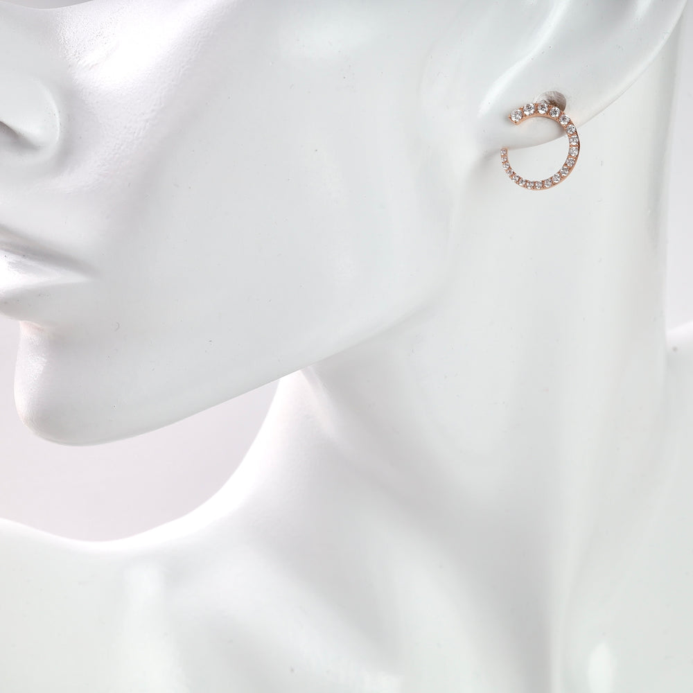 Rose gold hoop earrings with clear crystals, displayed on a white mannequin.