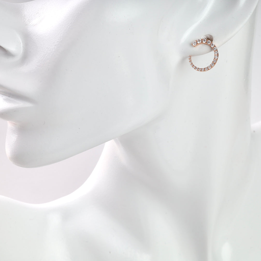 Rose gold hoop earrings with clear crystals, displayed on a white mannequin.