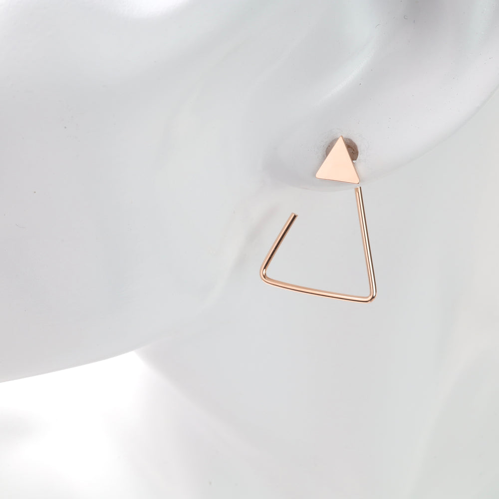 Single rose gold triangle stud with open triangle dangle on white mannequin ear, rose gold triangle earring and geometric dangle earring.