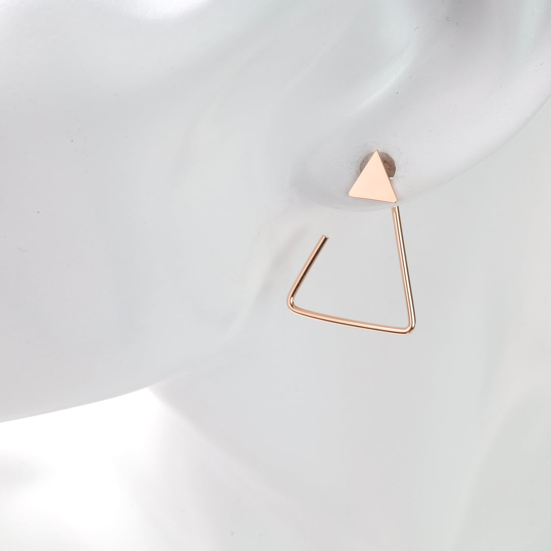 Single rose gold triangle stud with open triangle dangle on white mannequin ear, rose gold triangle earring and geometric dangle earring.