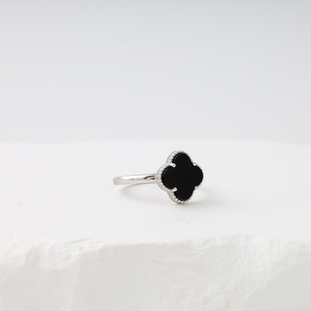 Sterling silver clover ring with black onyx, minimalist stackable band on white display, Ukrainian Jewelry gift for women.