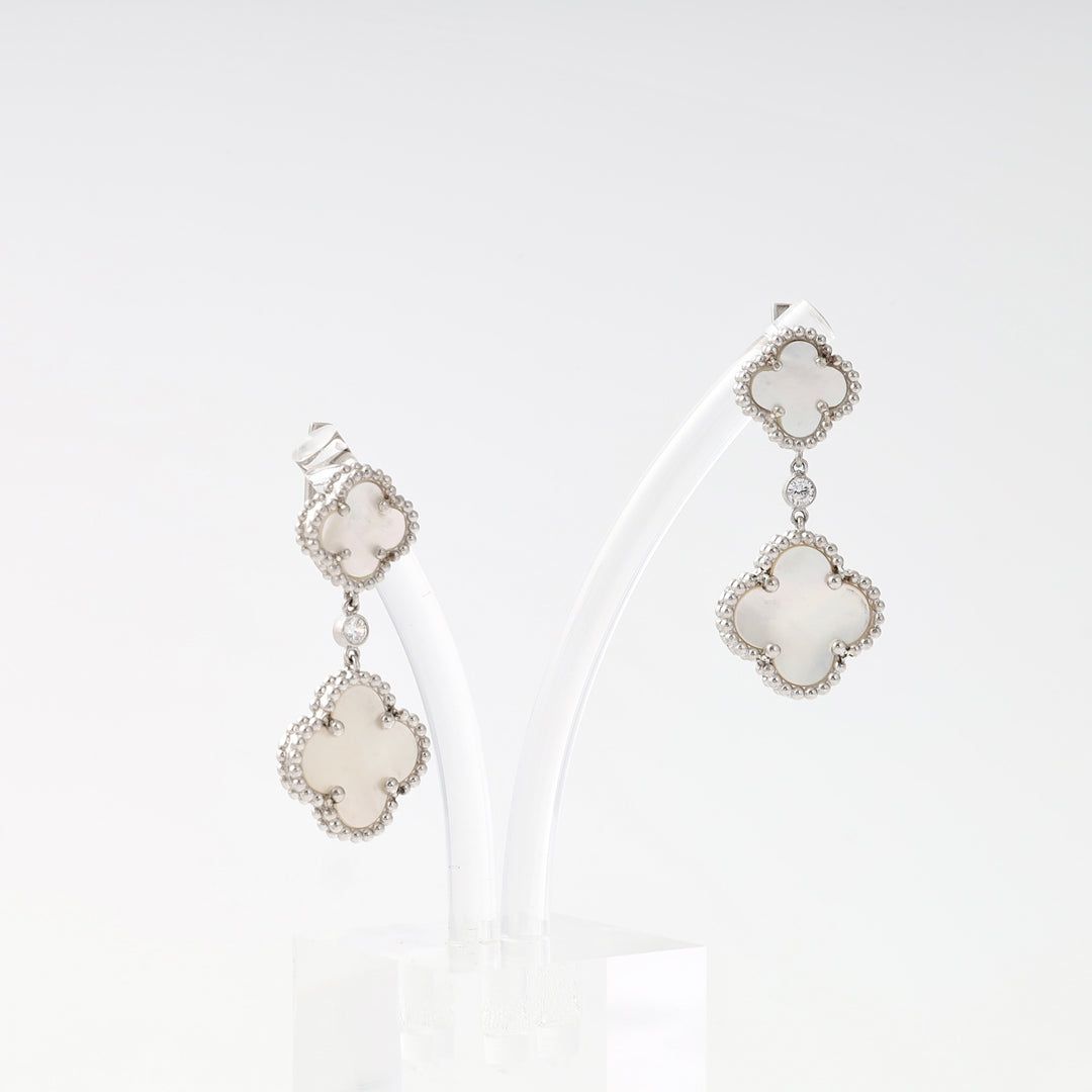 Sterling silver clover drop earrings with white inlay and crystal accents on display, Ukrainian Jewelry, silver dangle earrings gift.