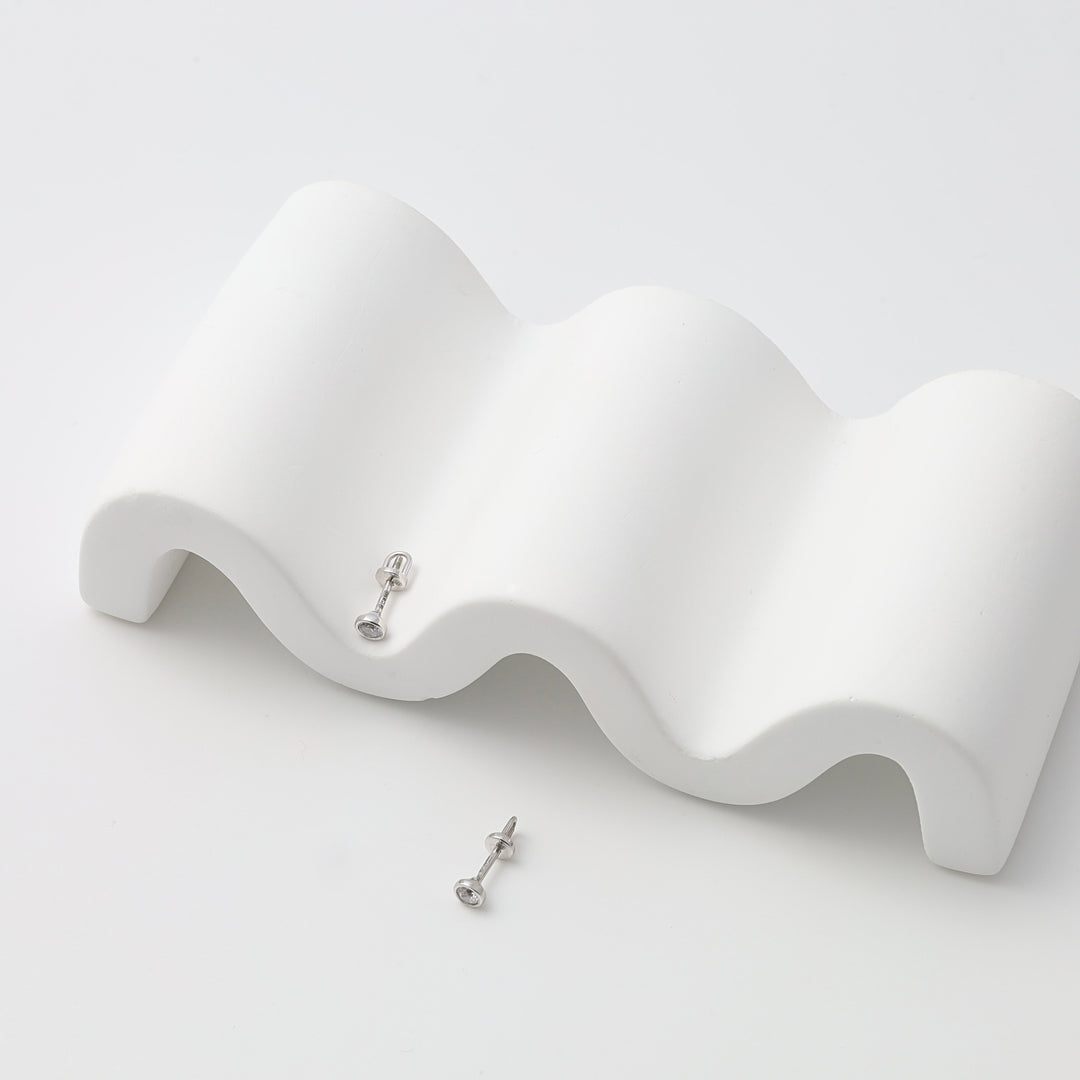 Sterling silver stud earrings with clear round stones on white display, minimalist Ukrainian Jewelry, dainty silver stud earrings.