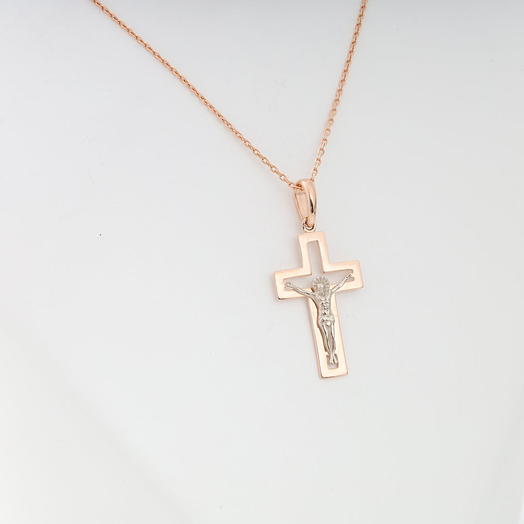 Rose gold crucifix pendant necklace featuring a silver Jesus motif displayed on a simple chain.