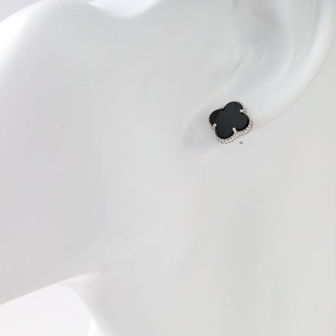 Sterling silver black clover stud earring on ear, minimalist Ukrainian Jewelry, dainty silver stud earrings for women.