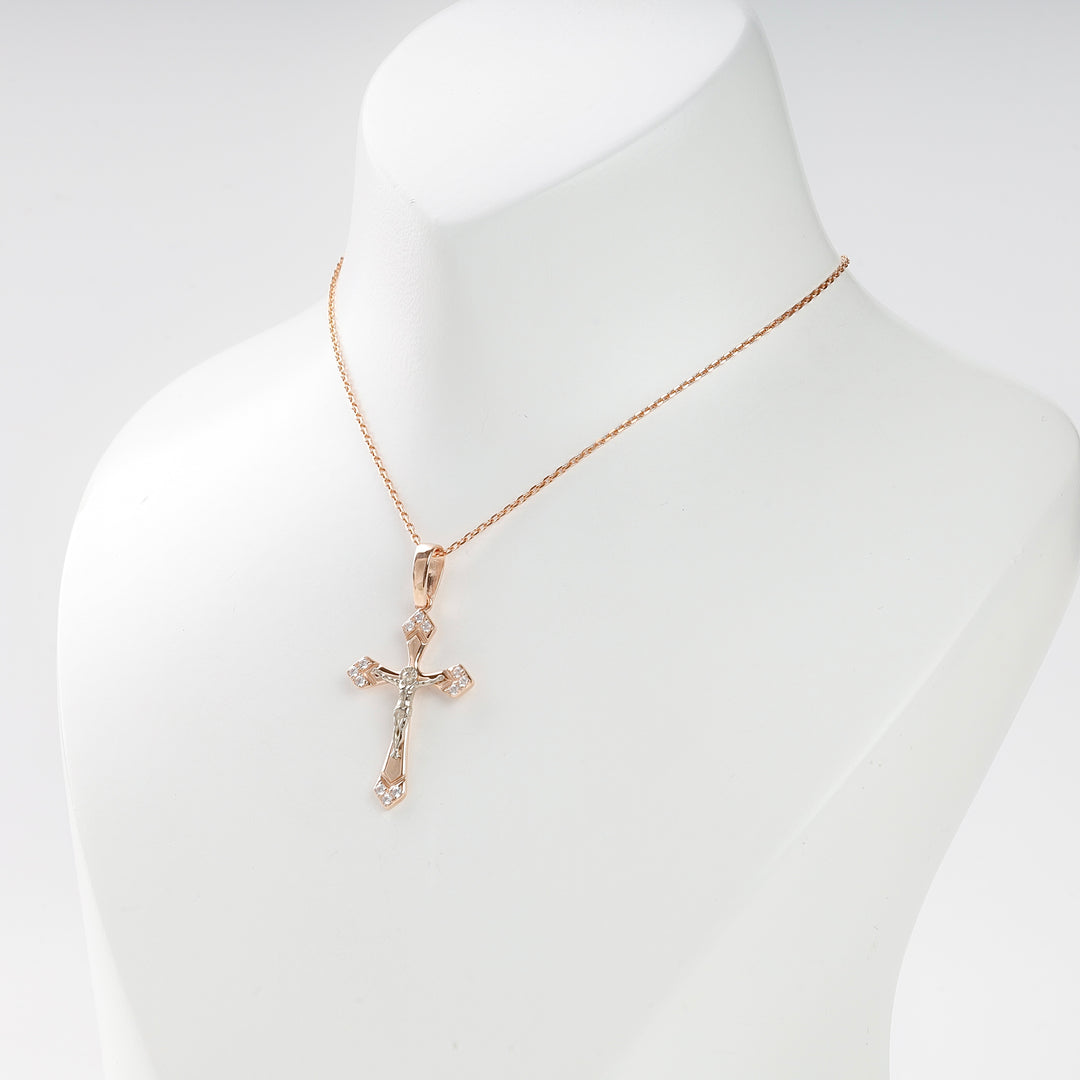 Gold crucifix pendant necklace with cubic zirconia accents displayed on a white bust. Christian jewelry, cross pendant.