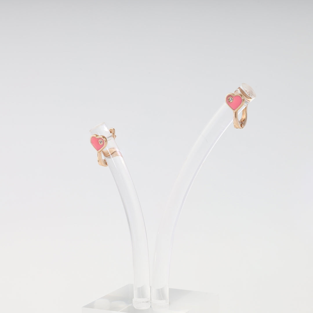 Gold heart huggie earrings with pink enamel and tiny stone on display, Ukrainian Jewelry, cute gold hoop earrings gift.