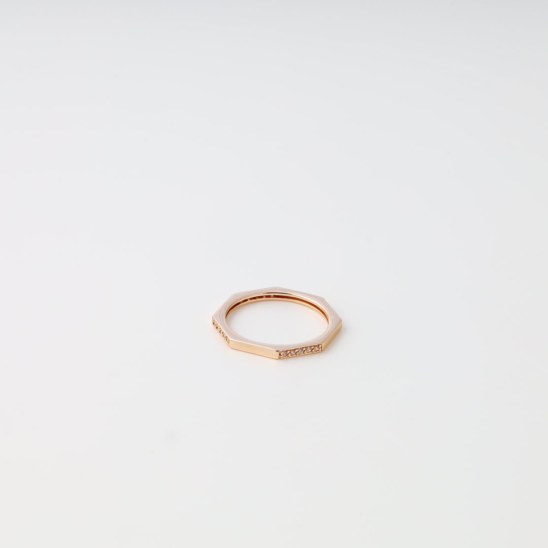 Rose gold 14k gold geometric ring with small diamonds on a white background, minimalist Ukrainian Jewelry wedding band.