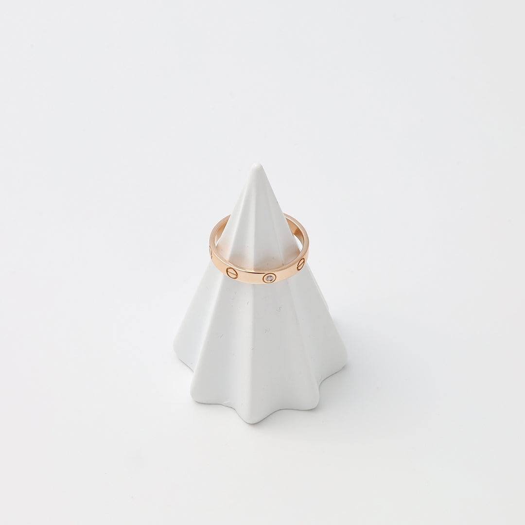 14k gold band ring with small circular motifs on a white cone display, minimalist wedding ring Ukrainian Jewelry.