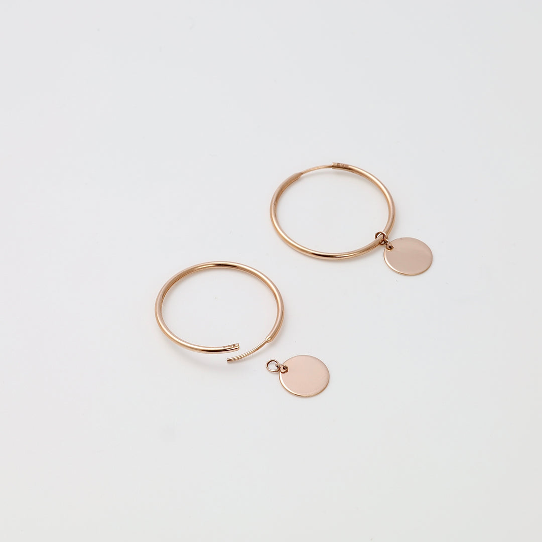 Rose gold hoop earrings with round disc charms, minimalist 14k gold jewelry, Ukrainian Jewelry for everyday hoop earrings shoppers.