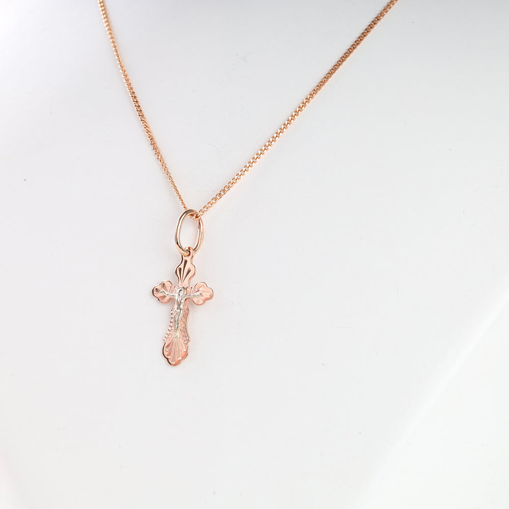 Rose gold cross pendant necklace with a delicate design shown on a display bust for religious jewelry, cross necklace, gift.