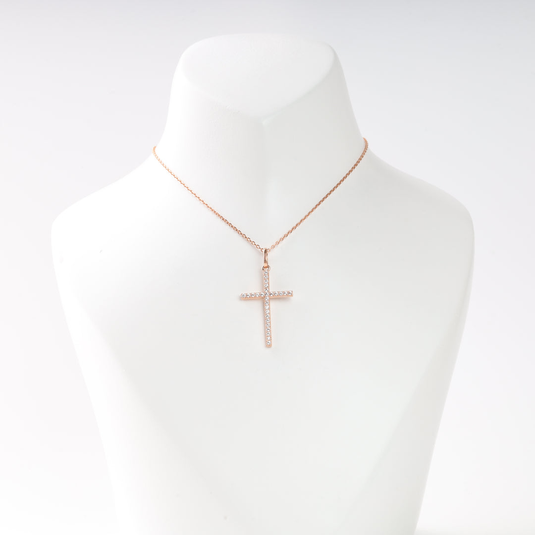 Rose gold chain necklace with a crystal cross pendant displayed on a white bust. Cross necklace, gold jewelry, religious gift.