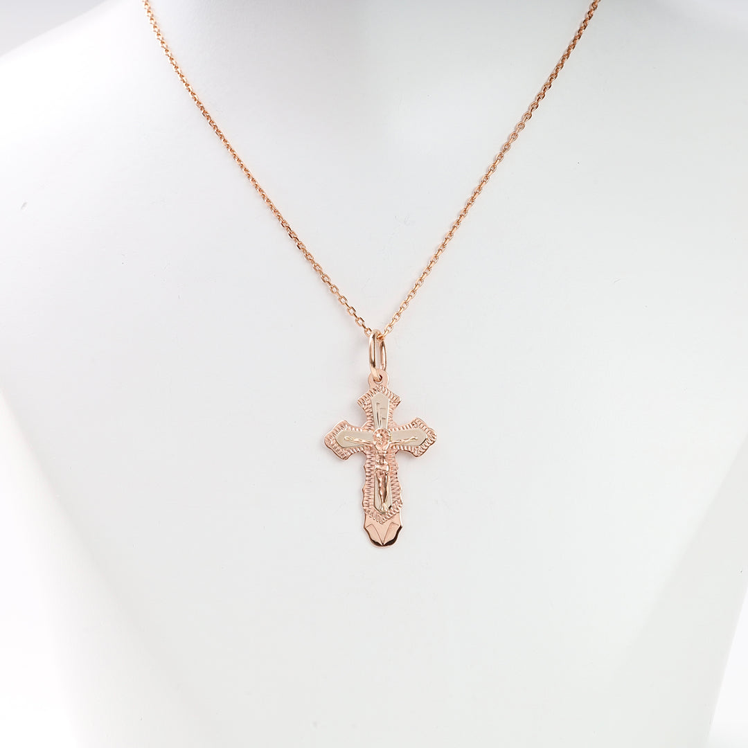 Rose gold cross pendant necklace with fine chain displayed on a white bust, religious jewelry, crucifix pendant.