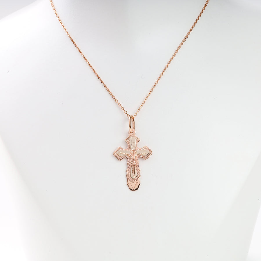 Rose gold cross pendant necklace with fine chain displayed on a white bust, religious jewelry, crucifix pendant.