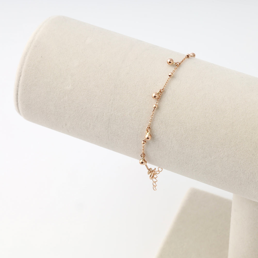 14k gold beaded chain bracelet displayed on a cream stand, delicate dainty women’s jewelry, Ukrainian Jewelry gift.