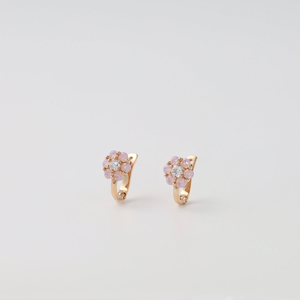 14k gold flower earrings with pink stones and crystals on white background, Ukrainian Jewelry, delicate gold hoop earrings for women.