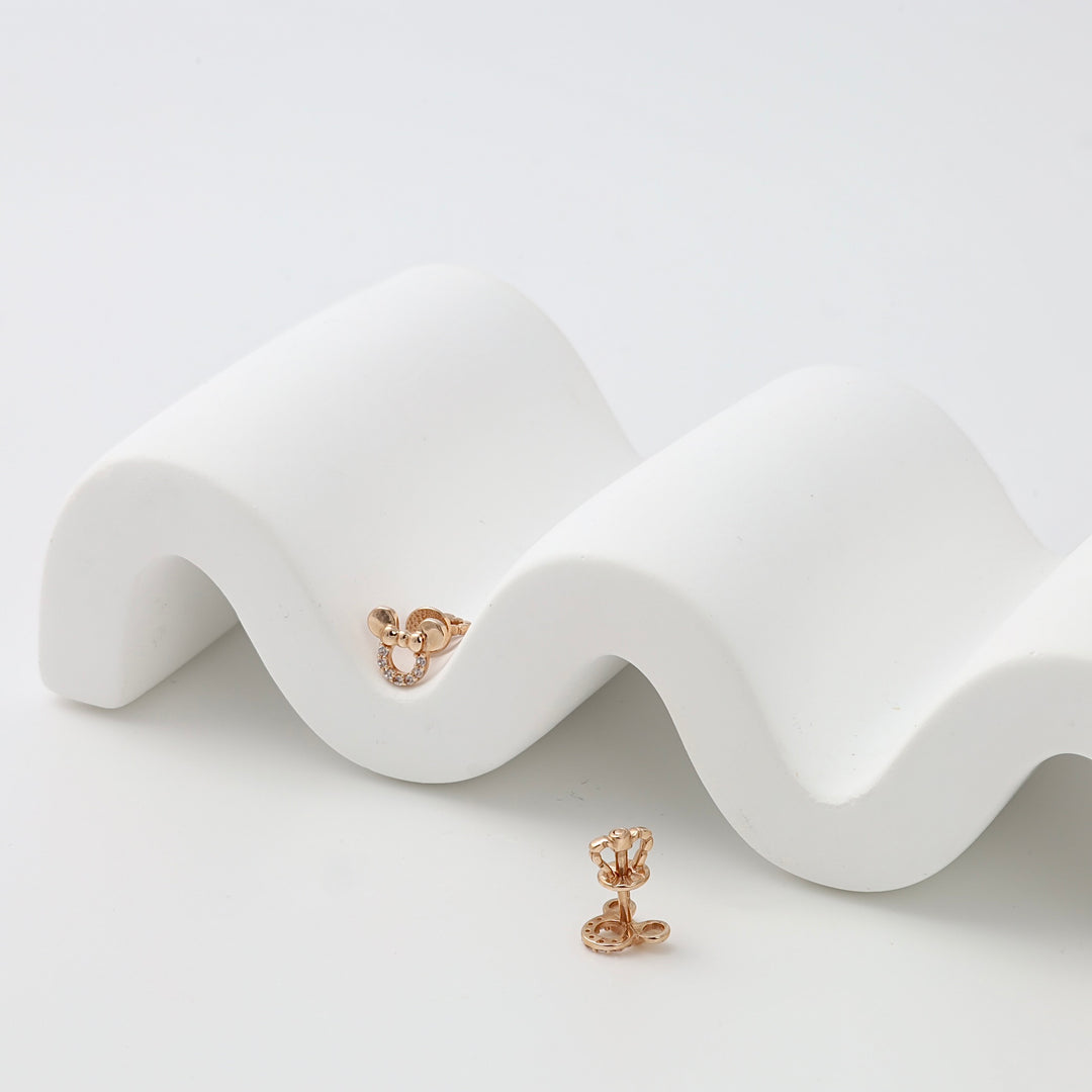 14k gold knot stud earrings with tiny crystal accents, minimalist gold earrings displayed on white for Ukrainian Jewelry shoppers.