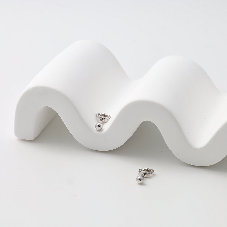 Pair of sterling silver heart stud earrings with drop ball detail on white display, minimalist Ukrainian Jewelry for everyday studs.