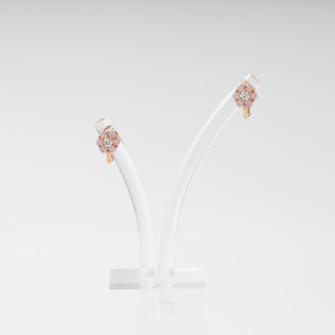 14k gold flower stud earrings with pink stones and crystals on clear display, Ukrainian Jewelry, dainty floral gold earrings.