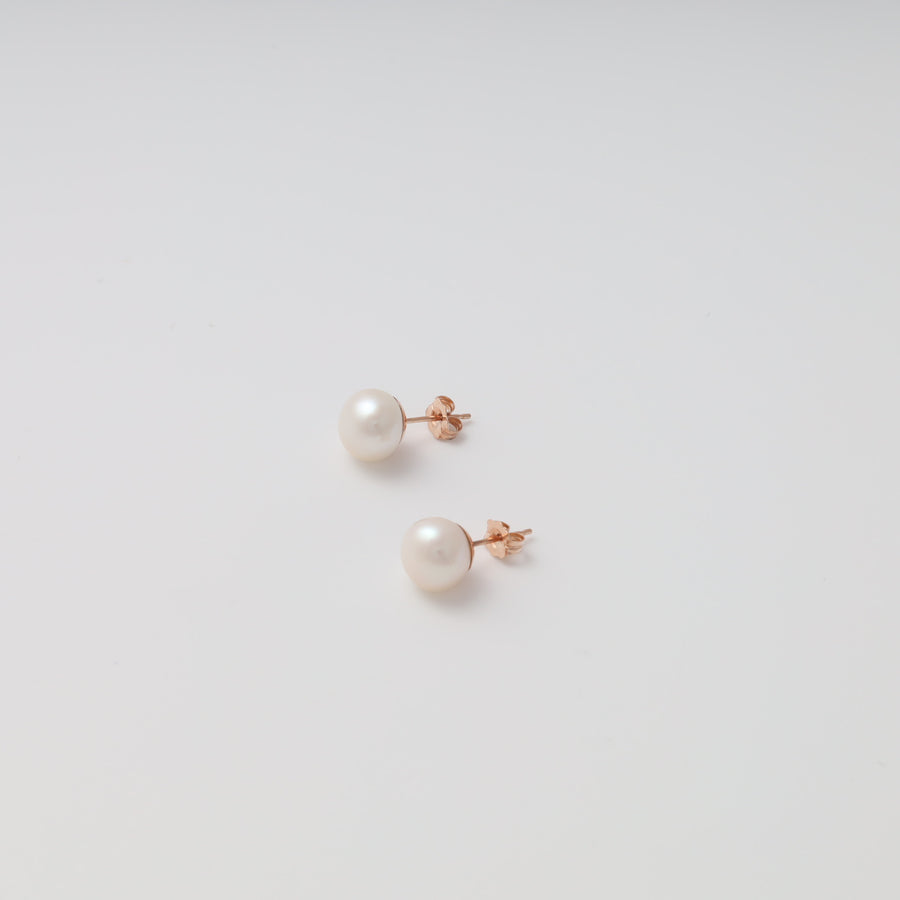 Pair of 14k gold pearl stud earrings on white background, classic Ukrainian Jewelry, minimalist pearl earrings gift.