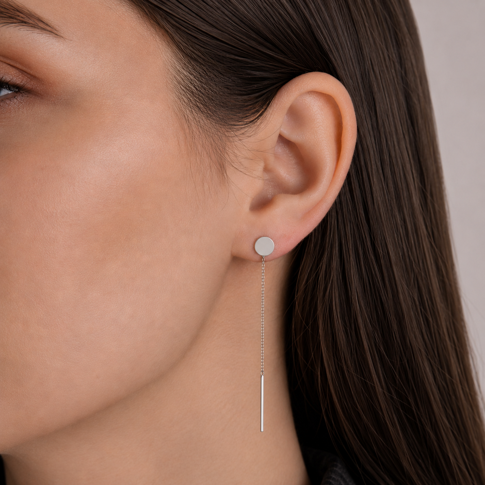 Model wearing a silver 925 disc threader earring