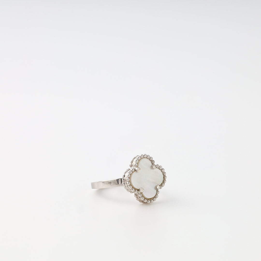 Sterling silver ring with white clover-shaped mother of pearl on plain background, Ukrainian Jewelry, silver ring, clover ring.