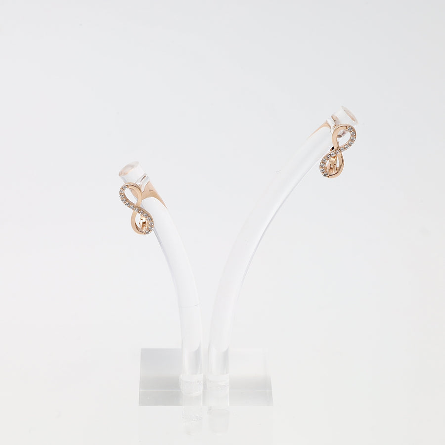 14k gold infinity stud earrings with small clear stones on a white display, Ukrainian Jewelry, delicate gold earrings gift.