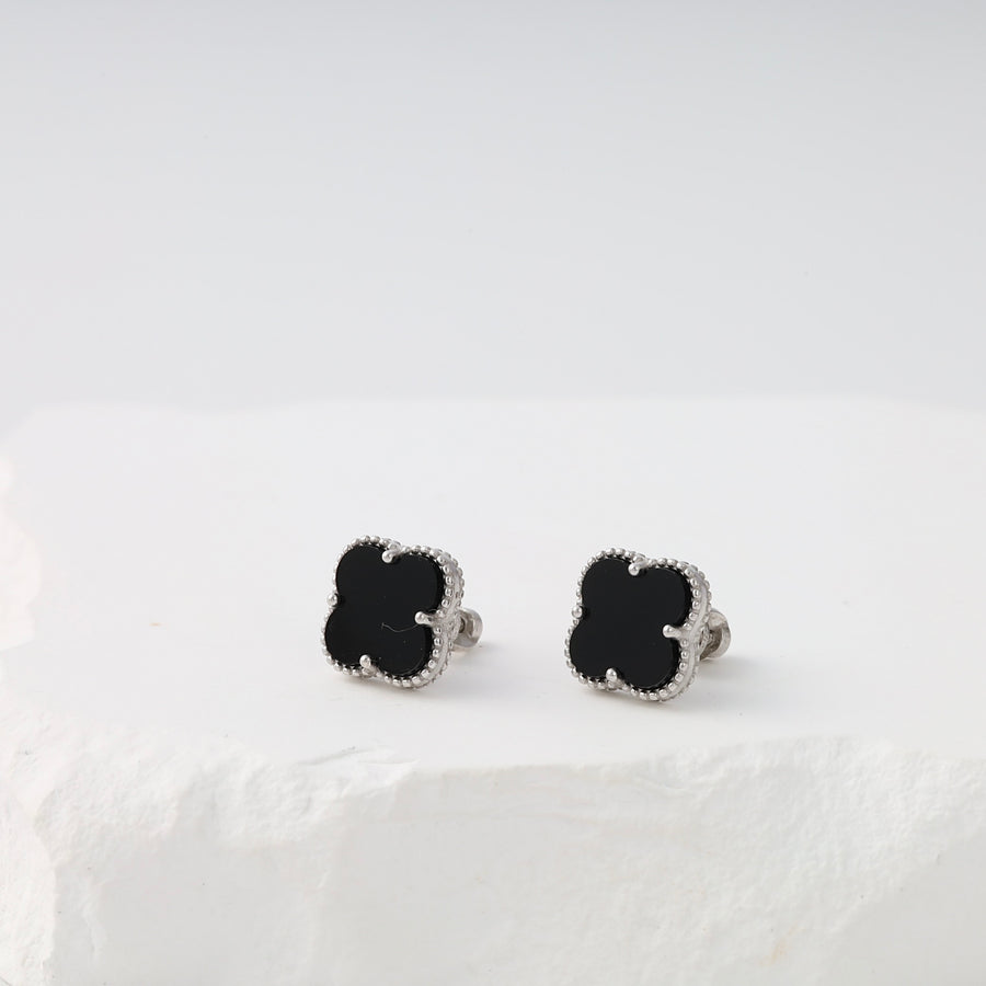 Sterling silver clover stud earrings with black enamel on white display, Ukrainian Jewelry for black stud earrings shoppers.