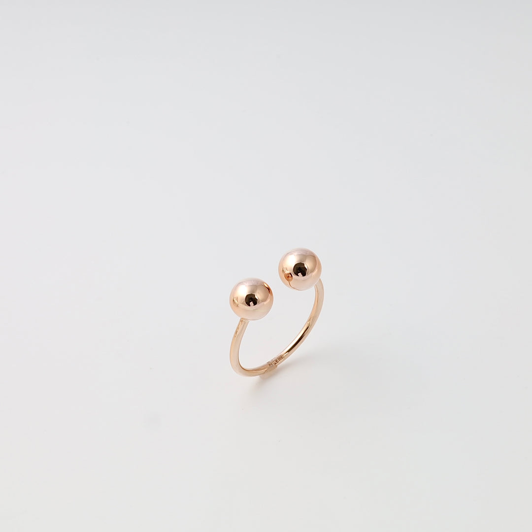 Open 14k gold adjustable ring with two polished ball ends on white background, minimalist Ukrainian Jewelry gift ring.