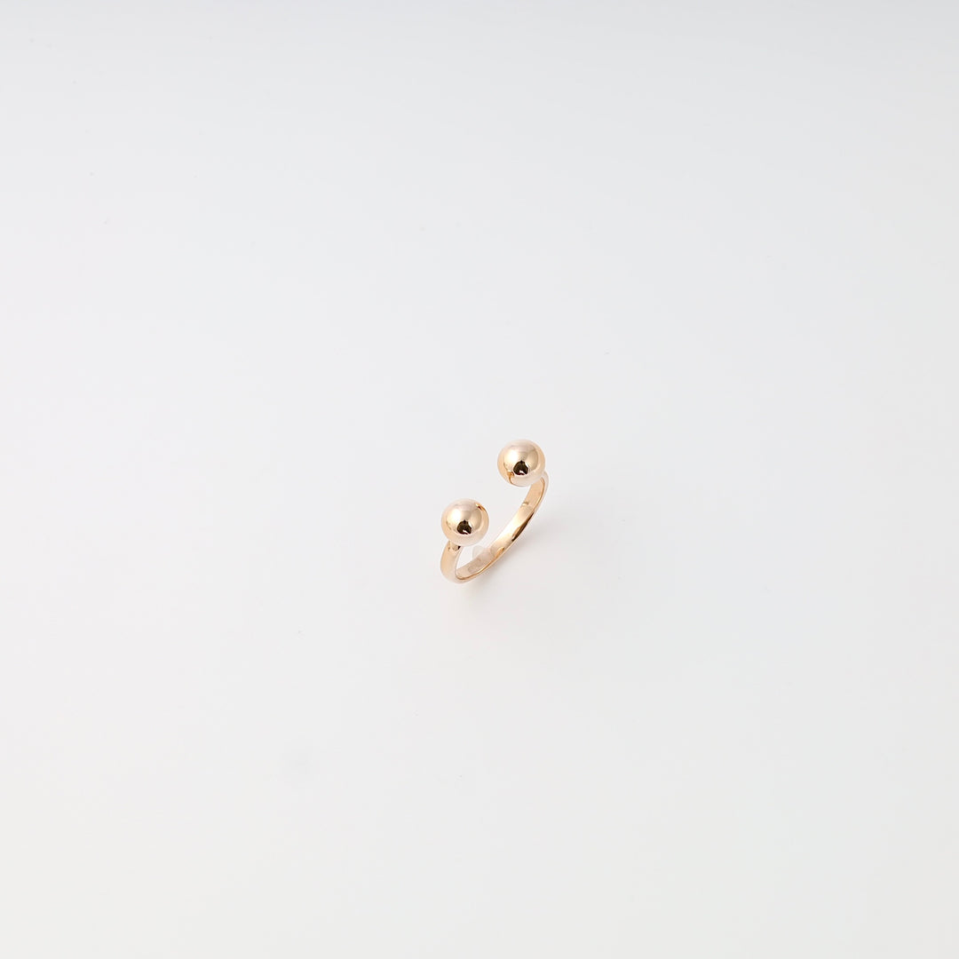 Minimalist 14k gold open ring with two ball ends on white background, Ukrainian Jewelry, modern gold ring, stacking ring.