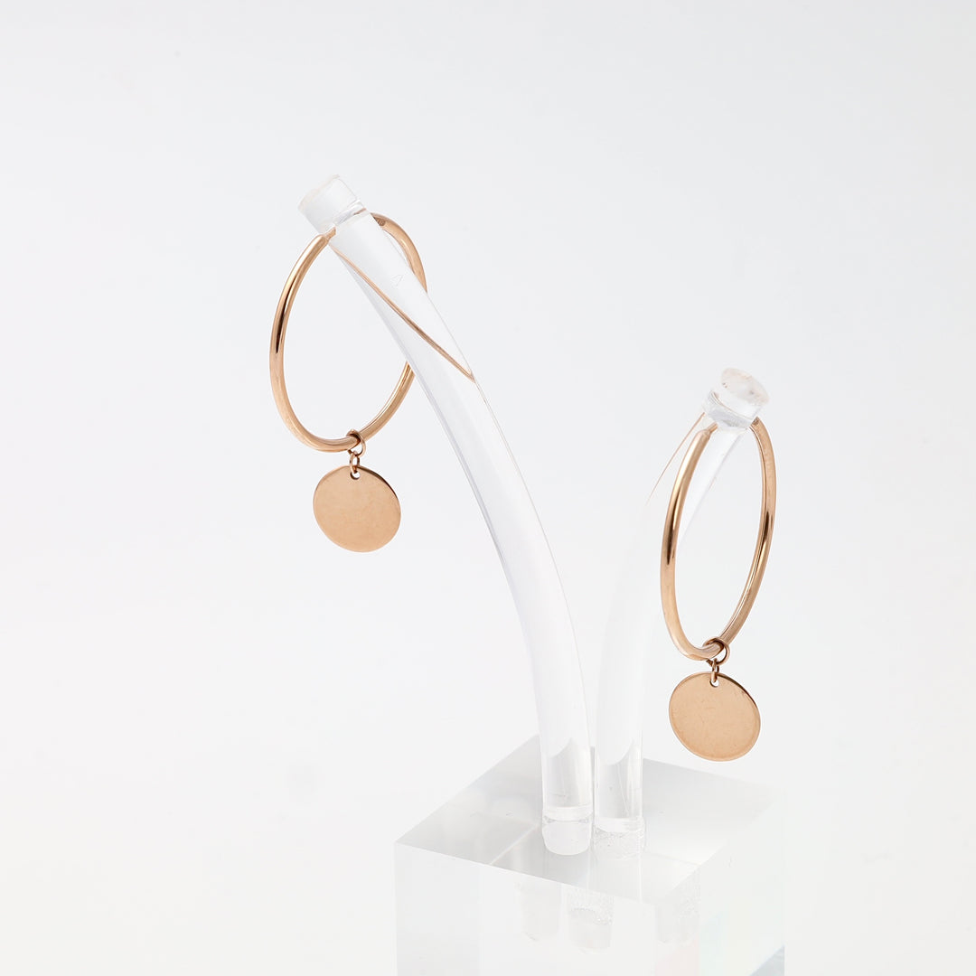 Pair of 14k gold hoop earrings with round disc charms on clear stand, minimalist dangle Ukrainian Jewelry for everyday wear.