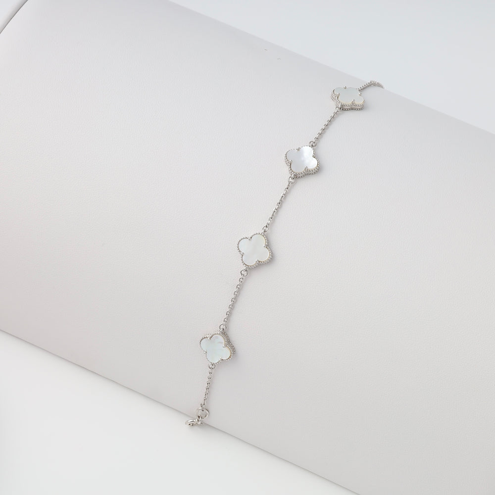 Sterling silver bracelet with four mother of pearl clover charms on a display, Ukrainian Jewelry, dainty silver chain bracelet.