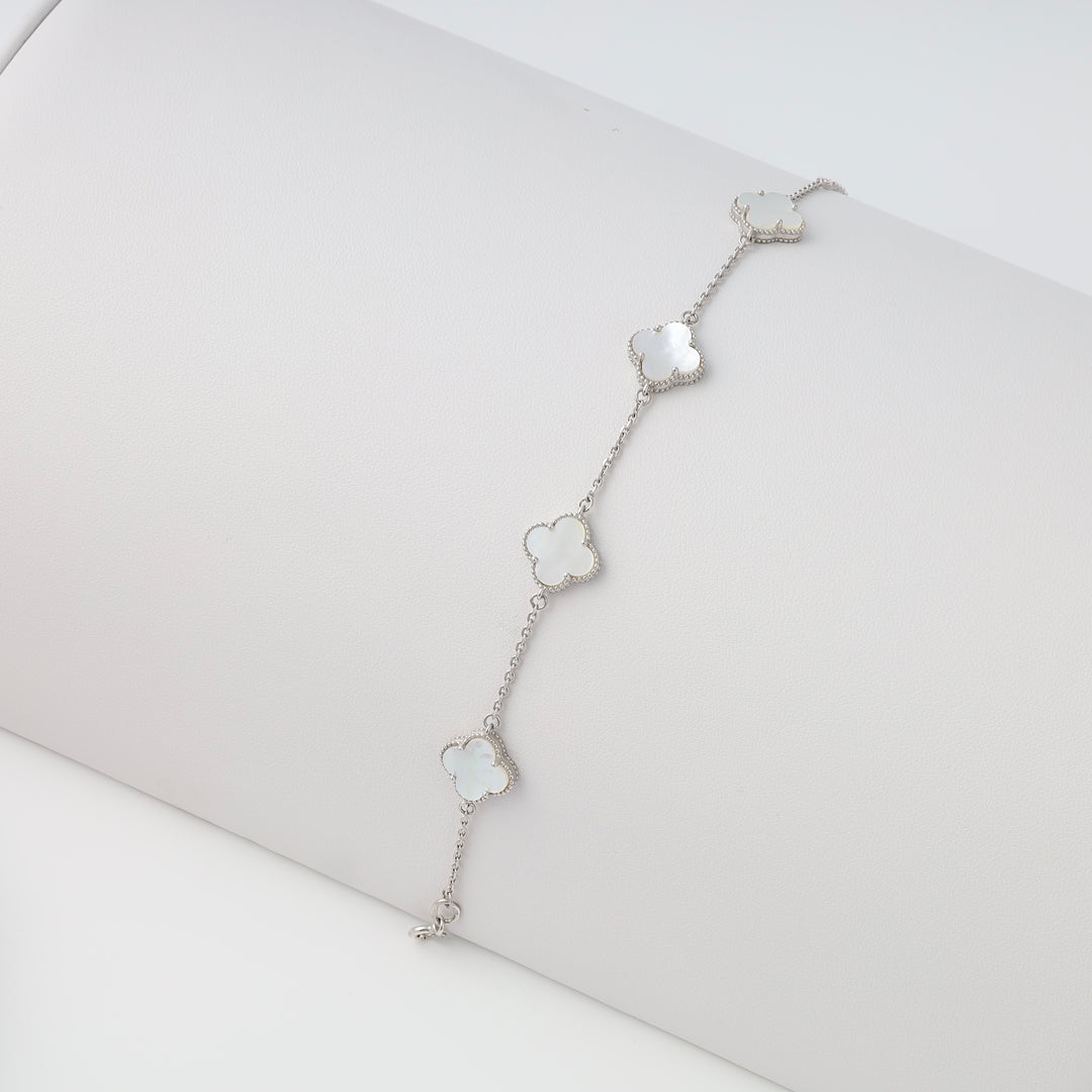 Sterling silver bracelet with four mother of pearl clover charms on a display, Ukrainian Jewelry, dainty silver chain bracelet.