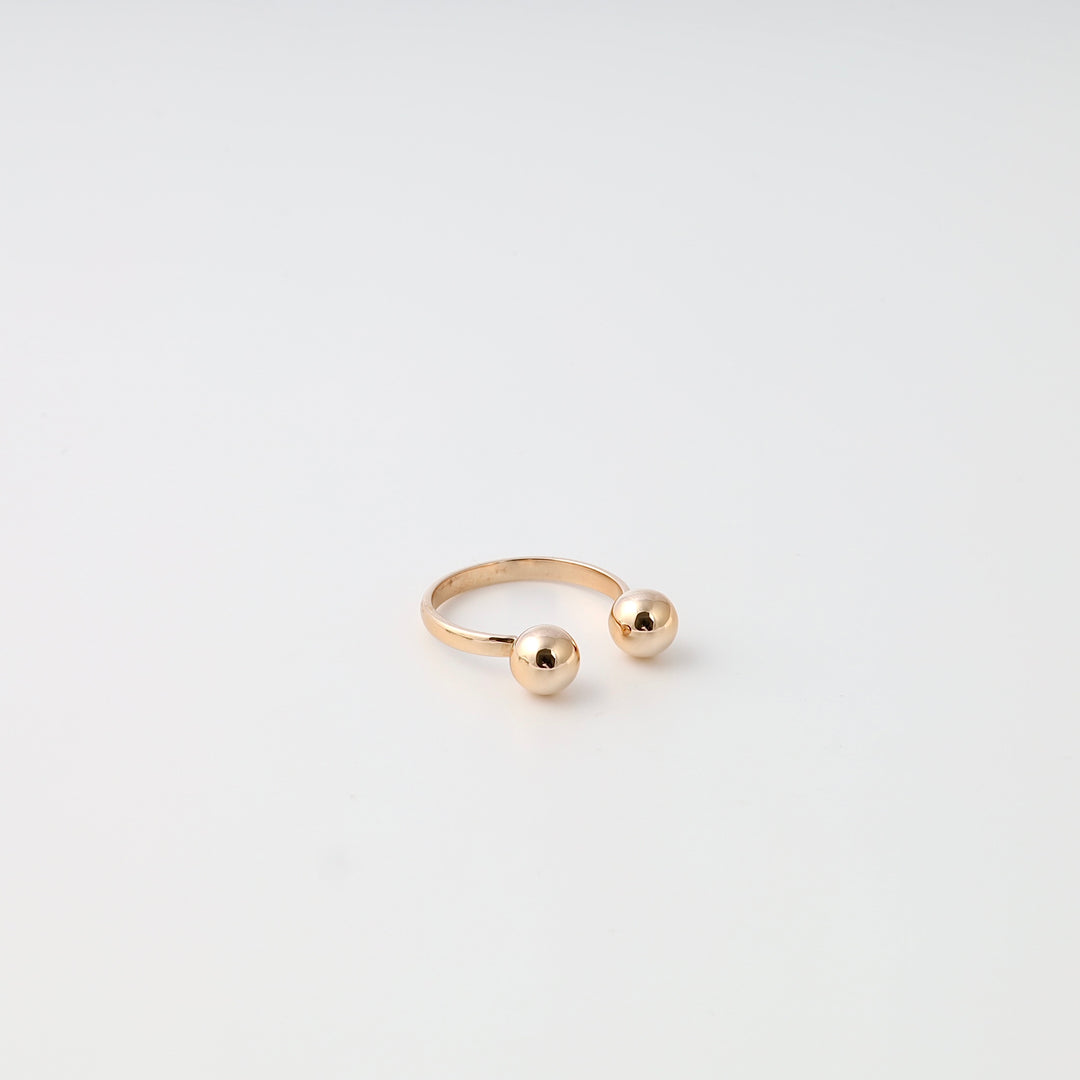 Minimalist 14k gold open ring with two polished ball ends, modern stackable band on white background, Ukrainian Jewelry for women.
